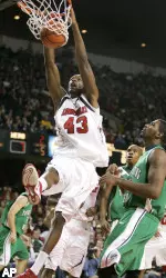 Terrance Farley dunks the ball over Marshall's Tyler Wilkerson during the first half. (AP Photo/Ed Reinke