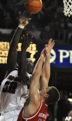 Derrick Caracter gets a shot up over the defense of Dayton's Kurt Huelsman during the first half. (AP Photo/Timothy D. Easley)