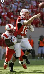 Brandon Cox tackles North Carolina State quarterback Harrison Beck as Beck passes during the first half. (AP Photo/Gerry Broome)