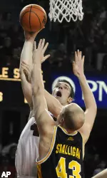 David Padgett gets a shot off over the defense of West Virginia's Jamie Smalligan during the second half Thursday night in Freedom Hall.
