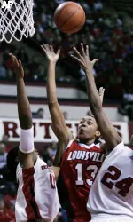 Louisville's Candyce Bingham (13) takes a shot as she splits Rutgers' defenders Kia Vaughn and Myia McCurdy (24) in the first half (AP Photo)