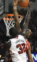 Derrick Caracter is fouled by St. John's Sean Evans during the second half.