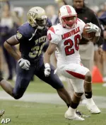 Victor Anderson rushes past Pitt's Greg Williams. (AP Photo/Keith Srakocic)