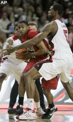 Earl Clark and Edgar Sosa pressure UNLV's Oscar Bellfield. (AP Photo)