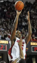 Earl Clark shoots over Ohio defenders. (AP Photo/Timothy D. Easley)