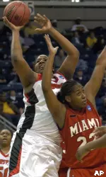 Chauntise Wright goes up for two points while guarded by Miami of Ohio's Chanell Ridley. (AP Photo/Jessica Hill)