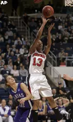 Candyce Bingham shoots past Kansas State's Shalee Lehning during the first half. (AP Photo/Ed Betz)