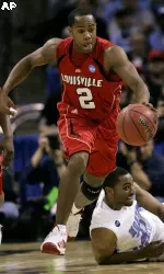 Louisville's Preston Knowles (2) drives up court past North Carolina's Deon Thompson, right, during the first half (AP Photo)