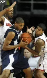 Oral Roberts Michael Craion, center, tries to keep the ball away from Samardo Samuels and Edgar Sosa during the first half.