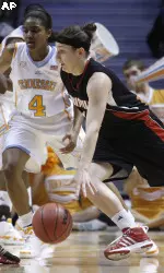 Becky Burke, right, drives against Tennessee's Kamiko Williams. (AP Photo/Wade Payne)