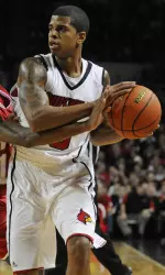 Edgar Sosa looks to pass as Western Kentucky's Jamal Crook, left, defends during the first half. (AP Photo/Timothy D. Easley)