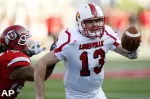 Louisville quarterback Justin Burke (13) is chased down by Utah linebacker Kepa Gaison (59). (AP)