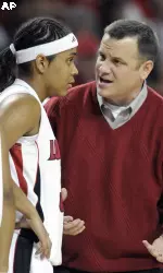 Louisville coach Jeff Walz, right, gives instruction to Monique Reid during the first half.