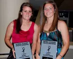 Katie Oliverio and Bergan Foley hold up their NCAA Division I Statistical Champion plaques.