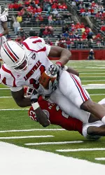 Andrell Smith (14) holds on to a reception as Rutgers' Brandon Bing (23) tackles him during the first half. (AP Photo/Tim Larsen)