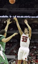 Mike Marra (33) launches this three-pointer over Marshall's Dago Pena. (AP)