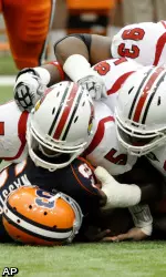 Syracuse quarterback Ryan Nassib is sacked by Louisville's Brandon Heath (5), Rodney Gnat (58) and Roy Philon (93). (AP)
