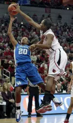 Louisville's Keshia Hines slaps down Kentucky's Maegan Conwright (20) shot during the first-half.