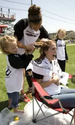 Friends of Jaclyn adoptee Emily Beck and Lianne Bobal shave mom, Carol Beck's hair at halftime as part of a fundraiser.