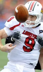 Suaesi Tuimaunei (28) knocks the ball away as Louisville's quarterback Adam Froman (9) crosses the goal line during the first half.