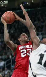 Louisville's Terrence Jennings (23) shoots against Providence's Kadeem Batts (10) in the first half. (AP Photo/Michael Dwyer)