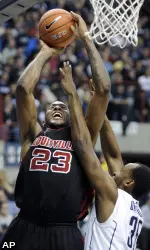 Louisville's Terrence Jennings goes up for a shot against UConn's Charles Okwandu.