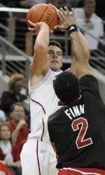 Kyle Kuric gets a shot off over the defense of Arkansas State's Trey Finn. Kuric scored 12 points.