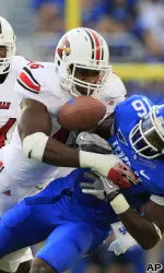 Louisville's Dexter Heyman knocks the ball loose from Kentucky's La'Rod King after a catch.