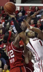 Rutgers' Khadijah Rushdan takes a shot past Louisville's Shawnta' Dyer during the first half. (AP Photo/Mel Evans)