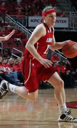 Becky Burke drives the ball down the court. Burke scored 13 points for the Cardinals.