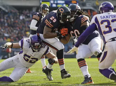 Chicago Bears running back Michael Bush (29) rushes one yard for a touchdown past Minnesota Vikings linebacker Chad Greenway (52) in the first half of an NFL football game in Chicago, Sunday, Nov. 25, 2012. (AP Photo/Nam Y. Huh)