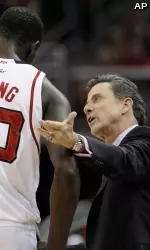 Louisville coach Rick Pitino talks to center Gorgui Dieng.