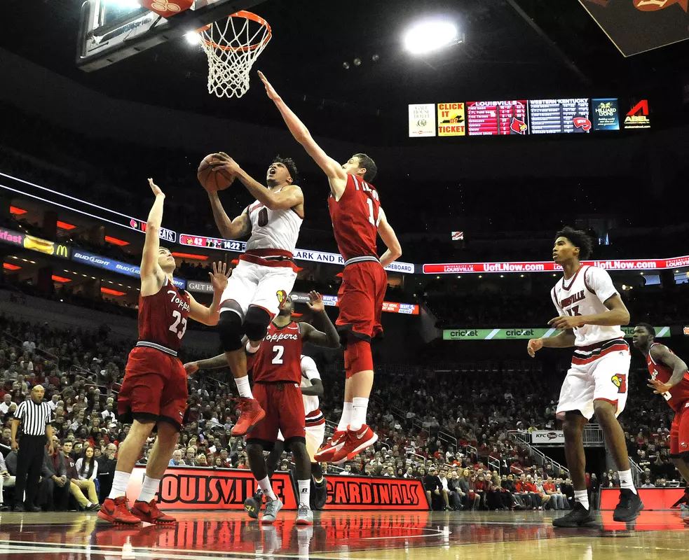 Louisville's Damion Lee (0) splits the defense of Western Kentucky's Justin Johnson (23) and Ben Lawson (14) for a layup during the second half of an NCAA college basketball game, Saturday, Dec. 19, 2015, in Louisville, Ky. Louisville won 78-56. (AP Photo/Timothy D. Easley)
