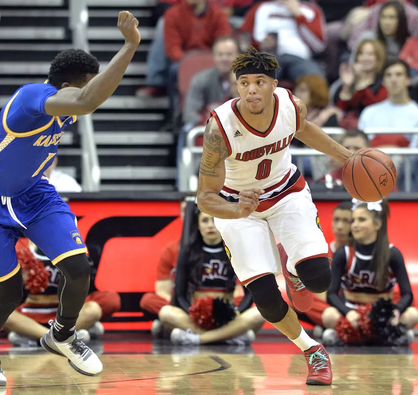 Louisville's Damion Lee (0) drives against UMKC's Dashawn King (1) during the first half of an NCAA college basketball game, Tuesday, Dec. 22, 2015, in Louisville, Ky. (AP Photo/Timothy D. Easley)