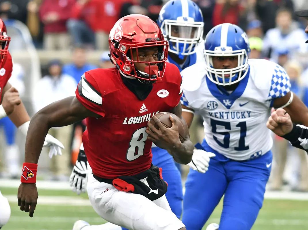 Louisville's Lamar Jackson (8) attempts to get away from the pursuit of Kentucky's Vourtney Love (51) during the first half of an NCAA college football game, Saturday, Nov. 26, 2016, in Louisville, Ky. (AP Photo/Timothy D. Easley)