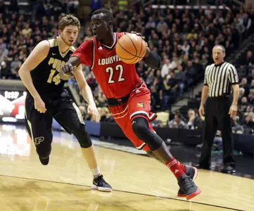 Louisville forward Deng Adel (22) drives on Purdue guard Ryan Cline (14) in the first half of an NCAA college basketball game in West Lafayette, Ind., Tuesday, Nov. 28, 2017. (AP Photo/Michael Conroy)