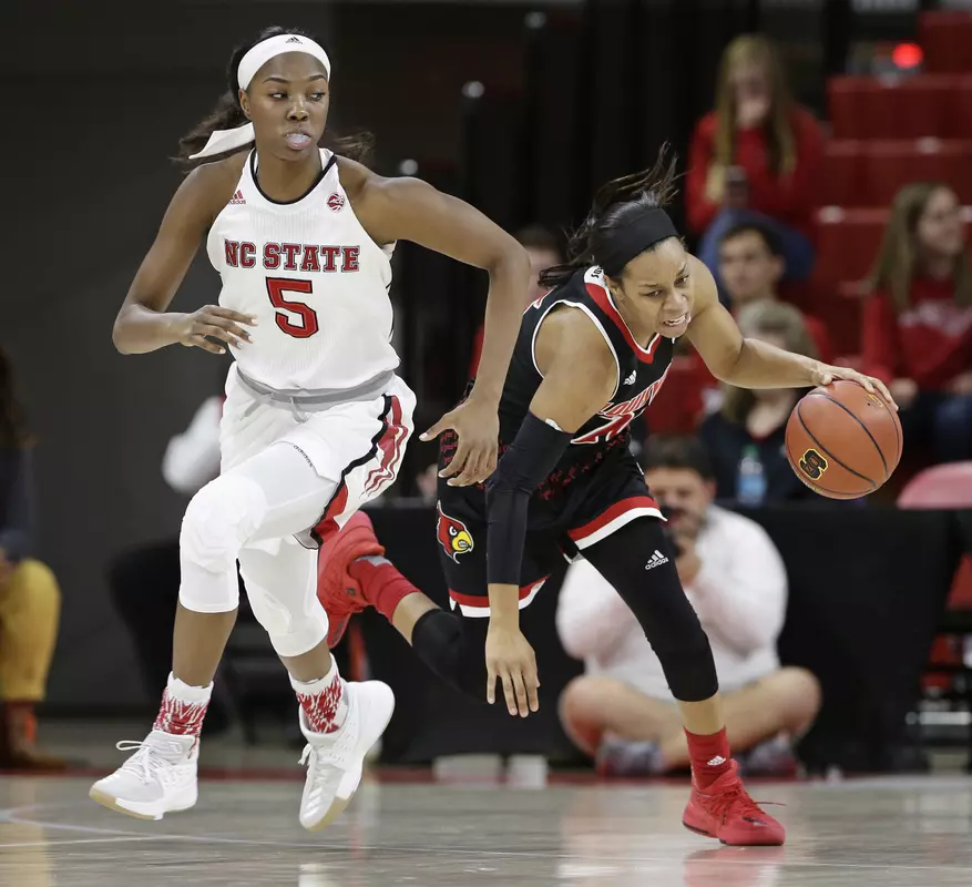 North Carolina State's Chelsea Nelson (5) and Louisville's Asia Durr chase the ball during the first half of an NCAA college basketball game in Raleigh, N.C., Sunday, Dec. 31, 2017. (AP Photo/Gerry Broome)