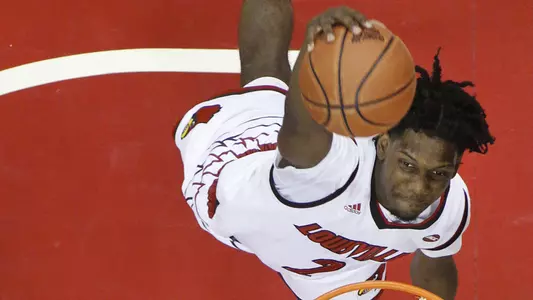UofL guard Darius Perry skies for a dunk in action during a game in the 2017-18 season, as seen from this overhead angle.