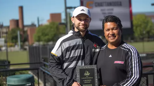 Christopher-Morin Kougoucheff poses with coach Rex Ecarma with the Louisville Invitational trophy