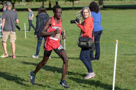 Emmanuel Cheboson gets inspiration from a fan during the Louisville Classic Cross Country Meet
