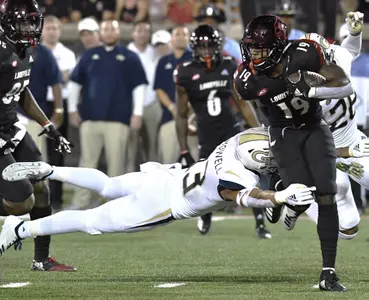 Georgia Tech defensive back Avery Showell (13) attempts a diving tackle on Louisville running back Hassan Hall (19) during the second half of an NCAA college football game, Friday, Oct. 5, 2018, in Louisville, Ky. Georgia Tech won 66-31. (AP Photo/Timothy D. Easley)