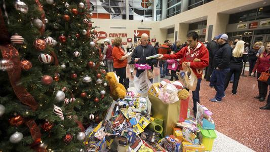 UofL fans pile up toys in the lobby of the KFC Yum! Center at a previous toy drive, similar to what will occur at its Dec. 12 men's basketball game.