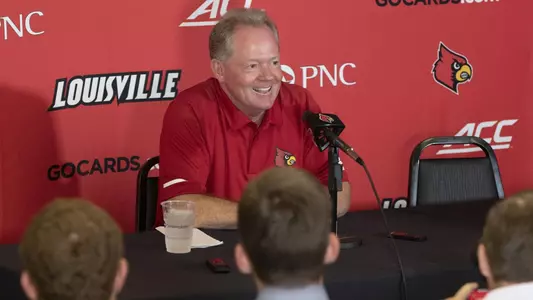 Head coach Bobby Petrino meets with the media in Cardinal Stadium during the program's media day.