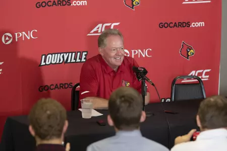 Head coach Bobby Petrino meets with the media in Cardinal Stadium during the program's media day.