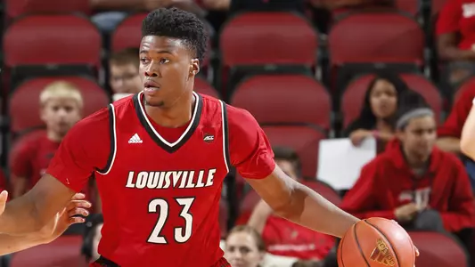 Center Steven Enoch dribbles for position in a Red-White intrasquad scrimmage last October in the KFC Yum! Center.