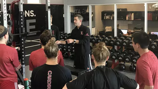 Jason Dierking talks with student-athletes inside the Marshall Center.