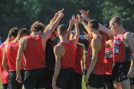 The Louisville men's cross country team huddles following their race at Commodore Classic.