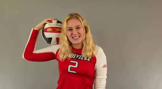 Shannon Shields poses with a Cardinal Volleyball.