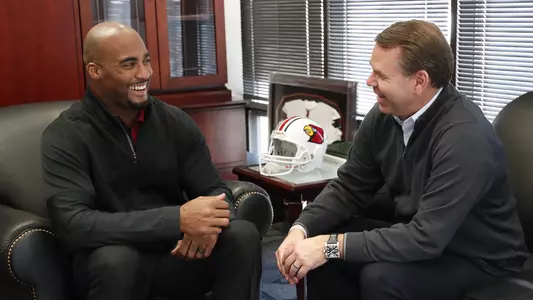 UofL Associate AD for Student Athlete Health and Performance Pat Ivey (left) visits with Vince Tyra, UofL VIce President and Director of Athletics, in Tyra's office on Jan. 29.