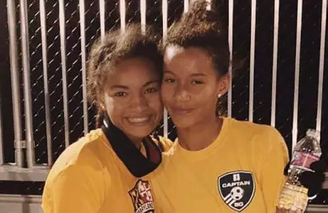 Gabrielle Vincent and her sister Marissa pose for a photo in their high school playing days